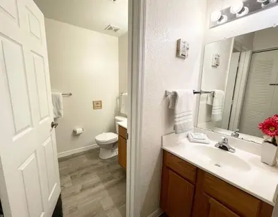 a bathroom with a sink and a toilet and a mirror at Family Friendly 3BR near Disney in Kissimmee