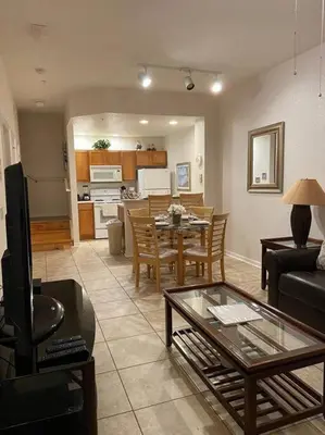 a living room with a table and a dining room at Family Friendly 3BR near Disney in Kissimmee