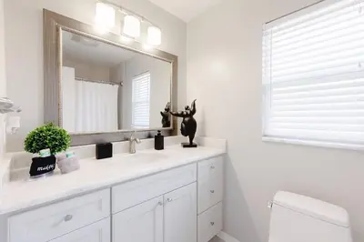 a bathroom with a sink and a mirror at Orlando Boho Villa in Kissimmee
