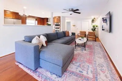 a living room with a blue couch and a rug at Orlando Boho Villa in Kissimmee