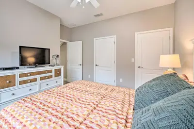 a bedroom with a bed and a flat screen tv at Private Pool and Lanai Resort Townhome in Kissimmee in Kissimmee