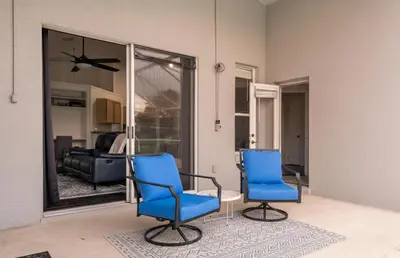 a living room with two blue chairs and a table at East Orlando Getaway - 3BR/2BTH - *Pool *Parking in Orlando
