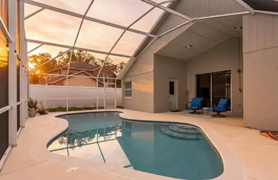 a swimming pool in a house with a glass ceiling at East Orlando Getaway - 3BR/2BTH - *Pool *Parking in Orlando