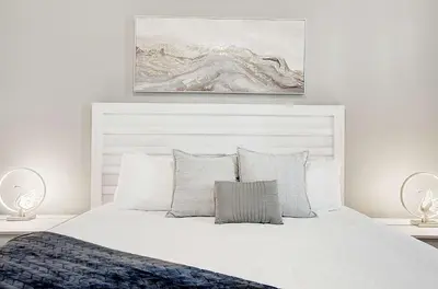 a bedroom with a white bed and a painting on the wall at 4721 Unit 105 BRAND NEW stunning apartment in Kissimmee