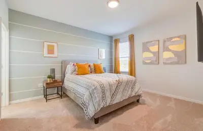 a bedroom with a bed with orange pillows on it at 6BR Resort Villa Near Disney Private Pool 2584 in Kissimmee
