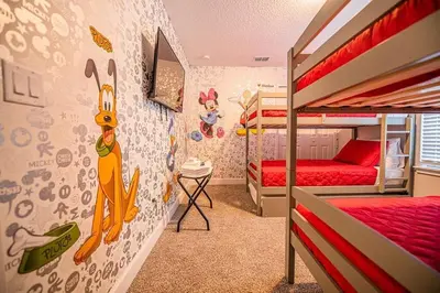 a bedroom with two bunk beds and a wall covered in stickers at Relax water view with Hammock near Disney 4736 in Kissimmee