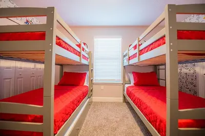 a bedroom with two bunk beds with red pillows at Relax water view with Hammock near Disney 4736 in Kissimmee