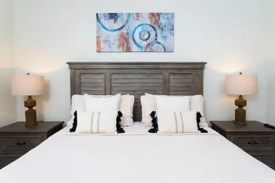 a bedroom with a large white bed with two lamps at Modern Condo with Lake View Near Disney 3151 in Kissimmee
