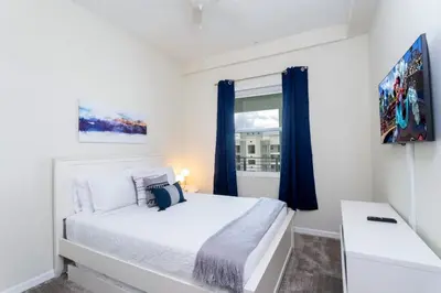 a bedroom with a white bed and a window at Modern Condo with Lake View Near Disney 3151 in Kissimmee