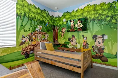 a bedroom with a mural of a forest at Resort Condo Near Disney FREE Waterpark 3120 in Kissimmee
