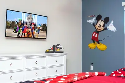 a bedroom with a tv on a wall at Special offer near Disney - free waterpark 2857 in Kissimmee