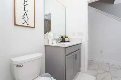 a bathroom with a white toilet and a mirror at free resort access, private pool near disney 2966 in Kissimmee