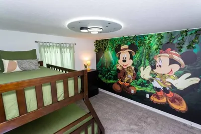 a bedroom with a bed and a mural of mickey mouse at FREE Waterpark 4BR Marvel Superhero-Themed 2967 in Kissimmee