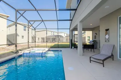 a swimming pool in a house with a large window at Resort-Style Private Pool & Spa Modern 2920 in Kissimmee