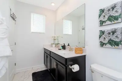 a bathroom with a sink and a mirror at Resort-Style Private Pool & Spa Modern 2920 in Kissimmee