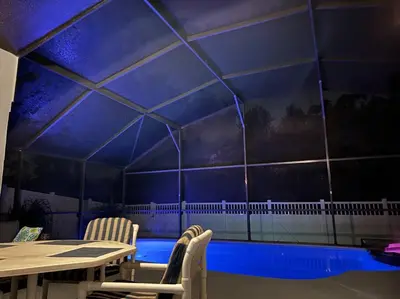 a room with a blue tiled wall with a table and chairs at Luxury Disney Family Villa (5-Bedroom, pool & spa) in Kissimmee