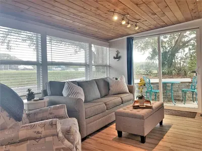 a living room with a couch and a table at FUN! PoolLake near Disney Fast WiFi Pickleball in Clermont