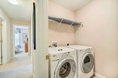 a laundry room with a washer and dryer at Kissimmee Getaway about 4 Mi to Walt Disney World in Kissimmee