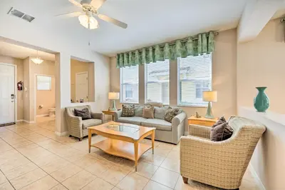 a living room with a couch and chairs and a table at Kissimmee Getaway about 4 Mi to Walt Disney World in Kissimmee