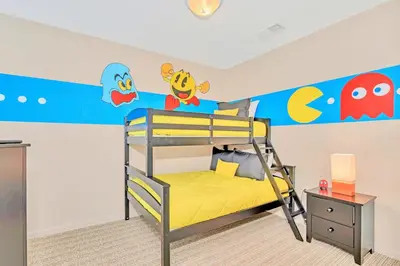 a bedroom with a bunk bed with a ocean themed wall at Spacious 3BR Condo with Pool near Disney in Orlando