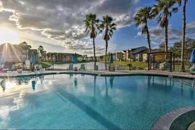 a large swimming pool with palm trees in the background at very Nice 2/2 apartment , close to disney in Kissimmee