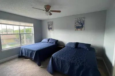 a bedroom with two beds and a ceiling fan at very Nice 2/2 apartment , close to disney in Kissimmee
