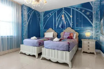 two beds in a room with blue walls at 7601-IBRAHIM · 7601 Themed 7BD Villa- Poolspa - Game room in Orlando
