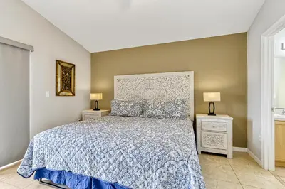 a bedroom with a large bed and two night stands at Star Lake Oasis - 4 bed family pool home in Orlando