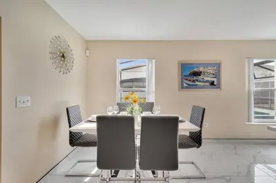 a dining room with a table and chairs at South Facing Pool, Close to Attractions, Remodeled in Kissimmee