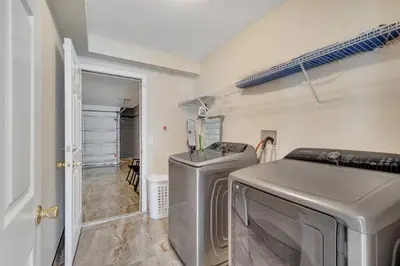 a laundry room with two washes and a washer and dryer at South Facing Pool, Close to Attractions, Remodeled in Kissimmee