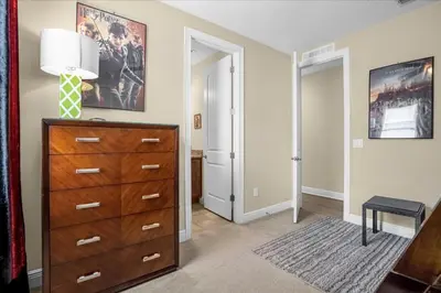 a living room with a dresser and a lamp at GREAT HOUSE Near Disney, Private Pool in Orlando