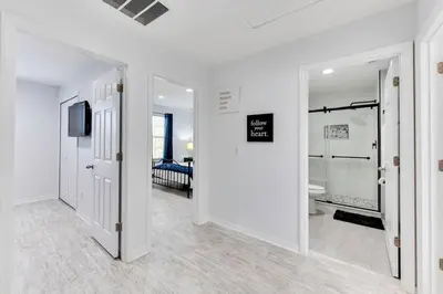 a white room with a bathroom with a toilet and a television at Welcome to Villa Azul, your home away from home! in Kissimmee