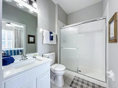a bathroom with a shower and a toilet and a sink at Private Pool Disney Townhome - Walk to Water Park in Orlando