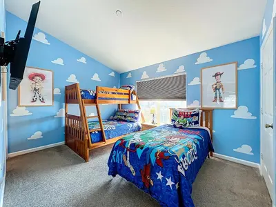 a childs bedroom with blue walls and a bunk bed at Private Pool Disney Townhome - Walk to Water Park in Orlando