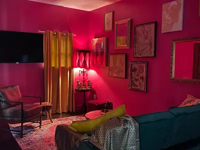 a living room with pink walls and a couch at Boho Nights in Sanford