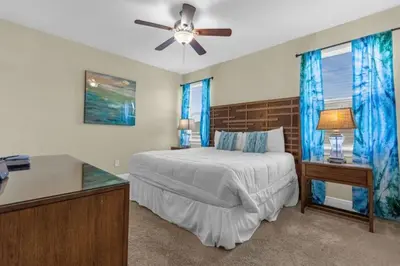a bedroom with a bed and a ceiling fan at 431 Villa - Spacious 7BD - Screened PoolSPA in Orlando