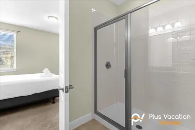a glass shower in a room with a bed at 561 - 8BD Villa - Private PoolSpa by Disney in Orlando