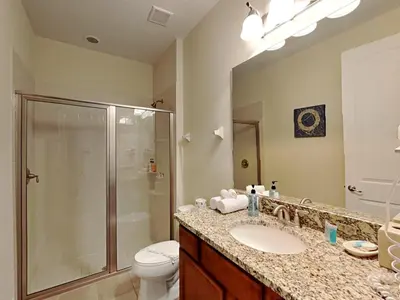 a bathroom with a shower and a sink and a toilet at 561 - 8BD Villa - Private PoolSpa by Disney in Orlando