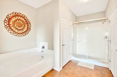 a bathroom with a tub and a shower at Stylish 3BR Suite with Swimming Pool - Near Disney in Orlando