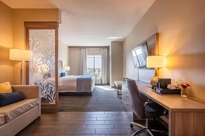 a hotel room with a bed and a desk in a room at Pestana Orlando Suites - Lake Buena Vista in Orlando