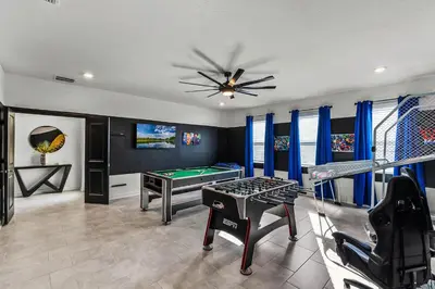 a game room with a ping pong table at Disney Dream Vacation Home by Disney in Kissimmee