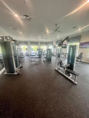 a gym with treadmills and machines in a room at Disney Dream Vacation Home by Disney in Kissimmee