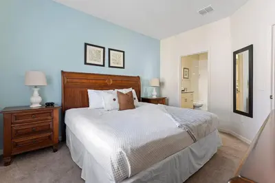 a bedroom with a bed and a dresser and a mirror at Welcoming 4 BR Sleeps 10 Guests WL2901 in Kissimmee