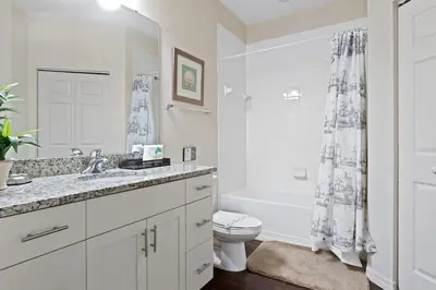 a white bathroom with a sink and a toilet at Welcoming 4 BR Sleeps 10 Guests WL2901 in Kissimmee