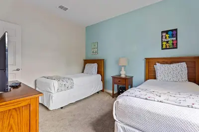 a bedroom with two beds and a flat screen tv at Welcoming 4 BR Sleeps 10 Guests WL2901 in Kissimmee