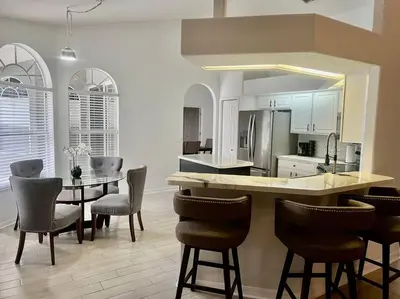 a kitchen and dining room with a table and chairs at Dreamy Family Pool House in Clermont