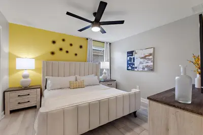 a bedroom with a large bed with a ceiling fan at Water Kingdom Storey Lake By Shine Villas #525 in Kissimmee
