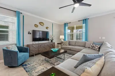 a living room with a couch and a tv at Water Kingdom Storey Lake By Shine Villas #525 in Kissimmee