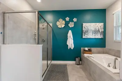 a bathroom with a shower and a bath tub at Water Kingdom Storey Lake By Shine Villas #525 in Kissimmee