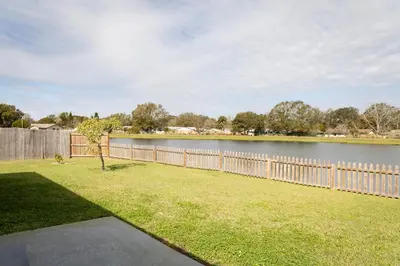 a fence next to a body of water at Florida Suburban Oasis ~ Lk Mary/Sanford Florida! in Sanford